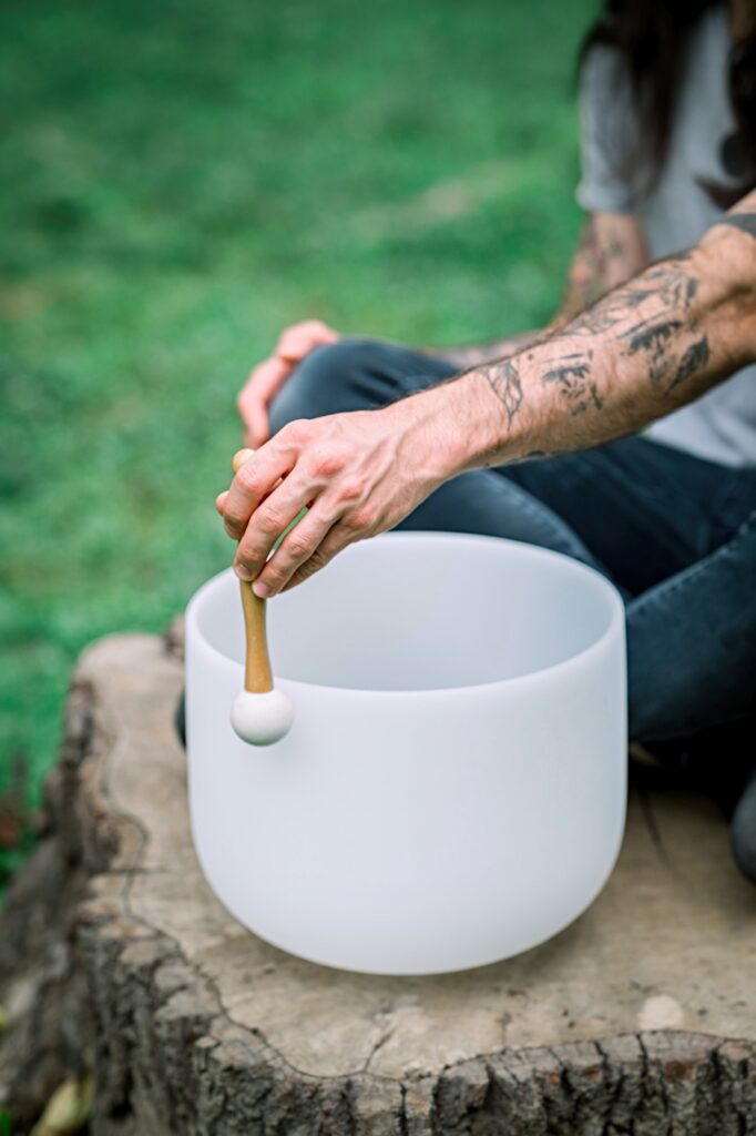 Man playing a singing bowl for sound healing