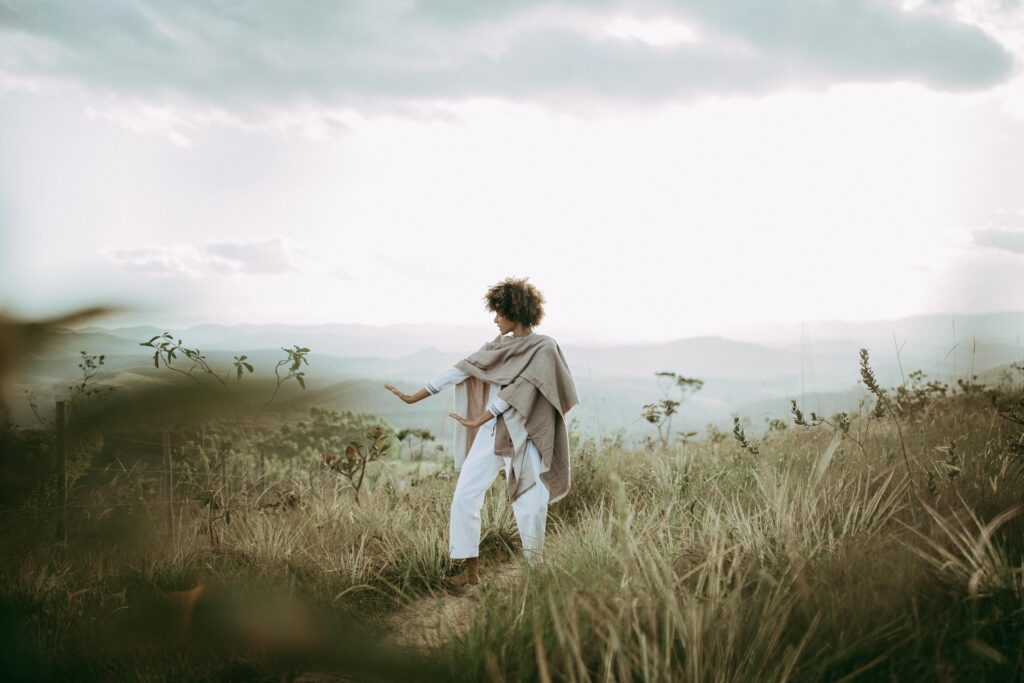 Woman practicing tai chi on a hill