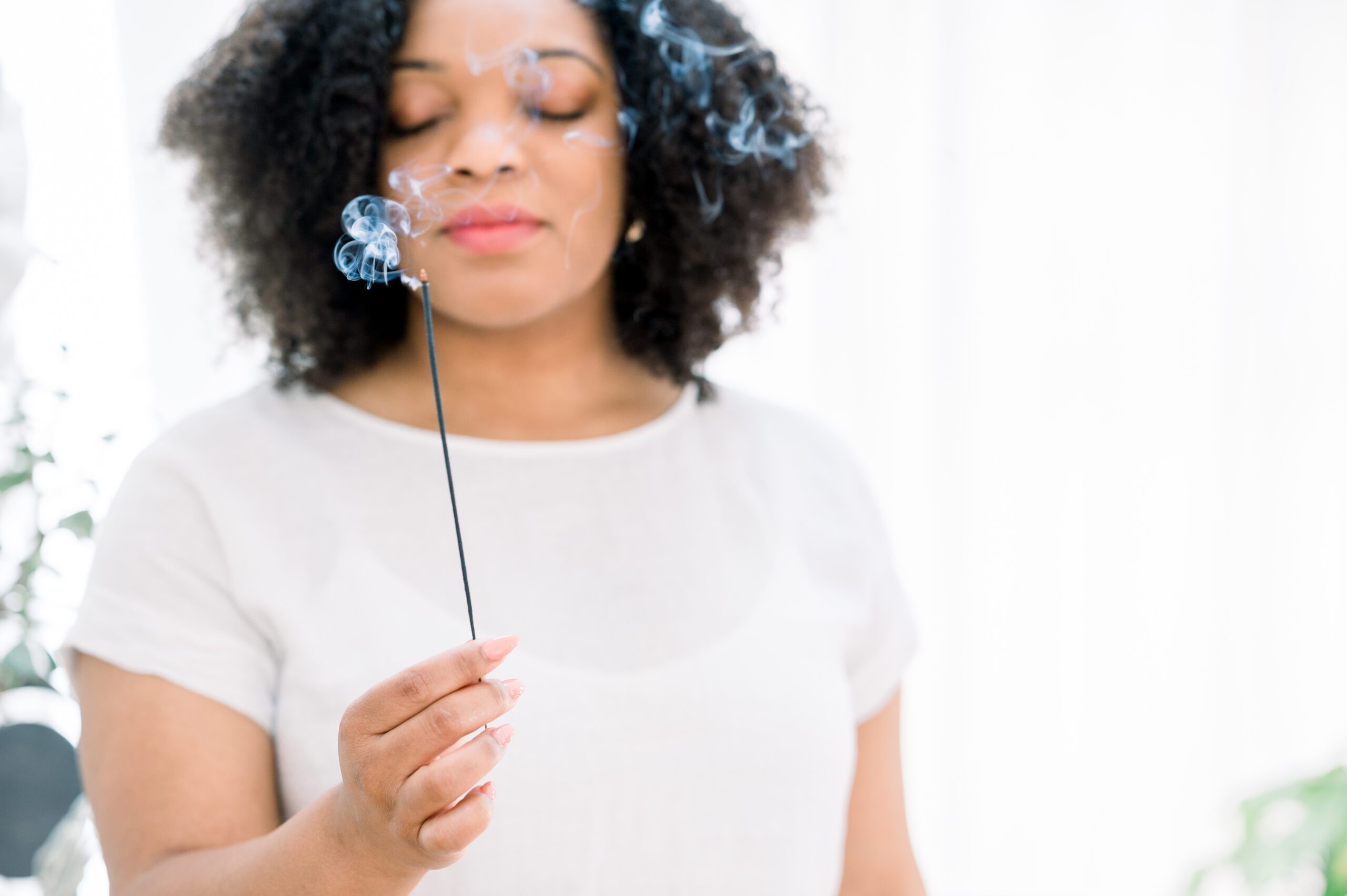 Woman in meditation with incense