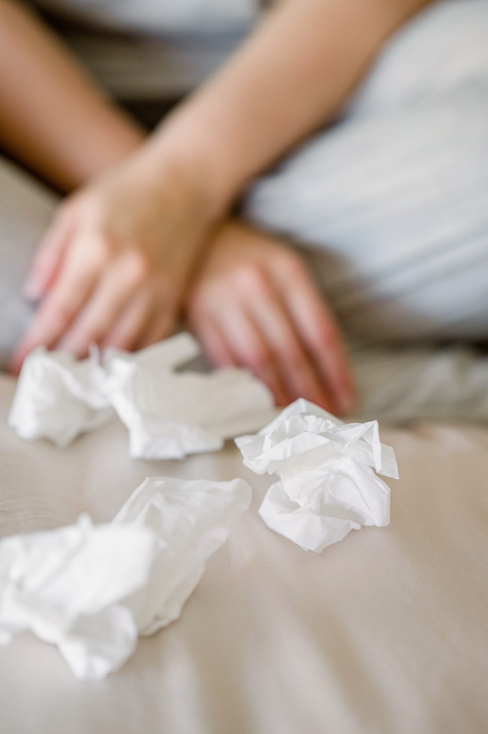 hands with crumpled tissues