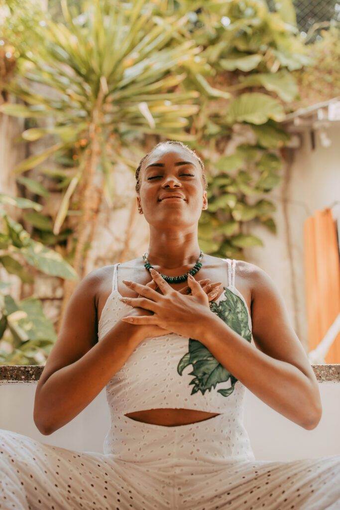 Woman in meditative pose with hands over heart