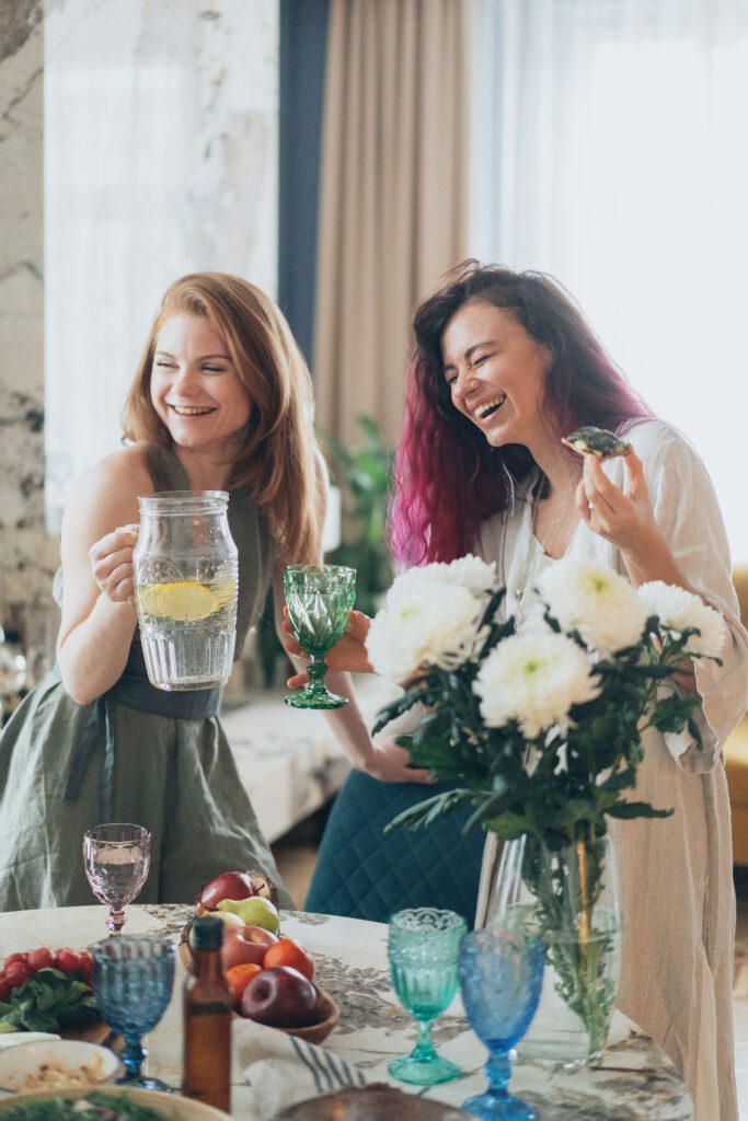 Woman with lemonade laughing with friend