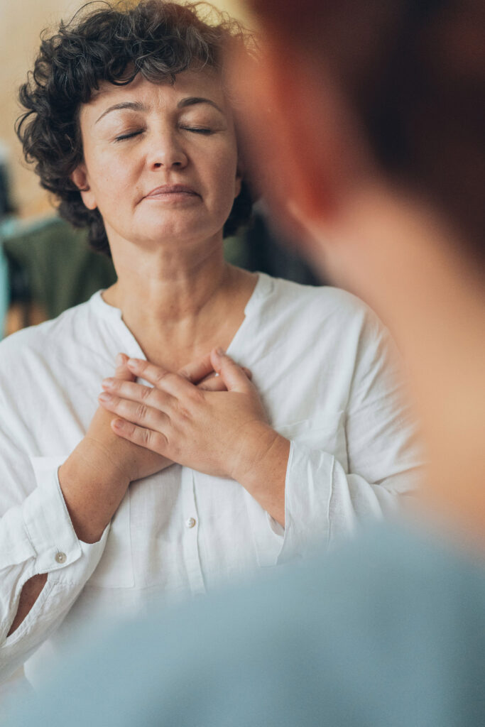 Woman with hands on heart