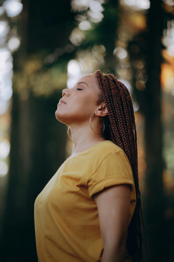 Woman outside with eyes closed